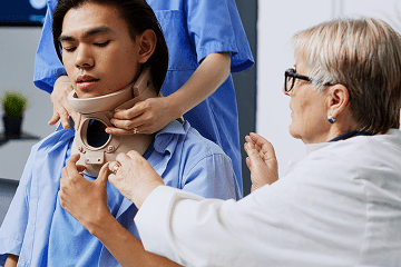 ABOUT US 6 Doctor assisting patient with neck support during ENT neck treatment