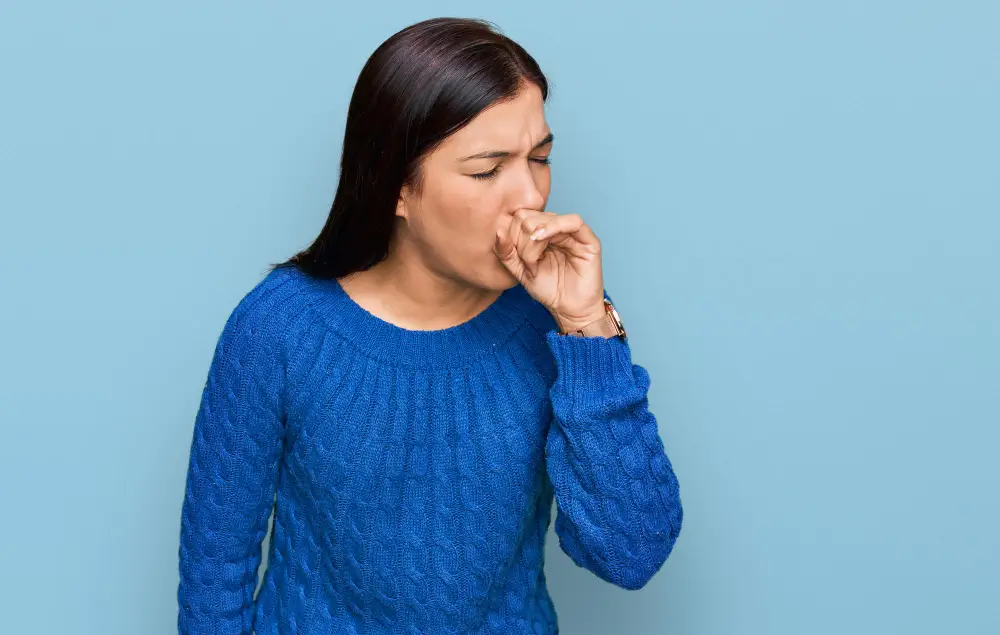 Woman coughing due to throat infection or respiratory irritation